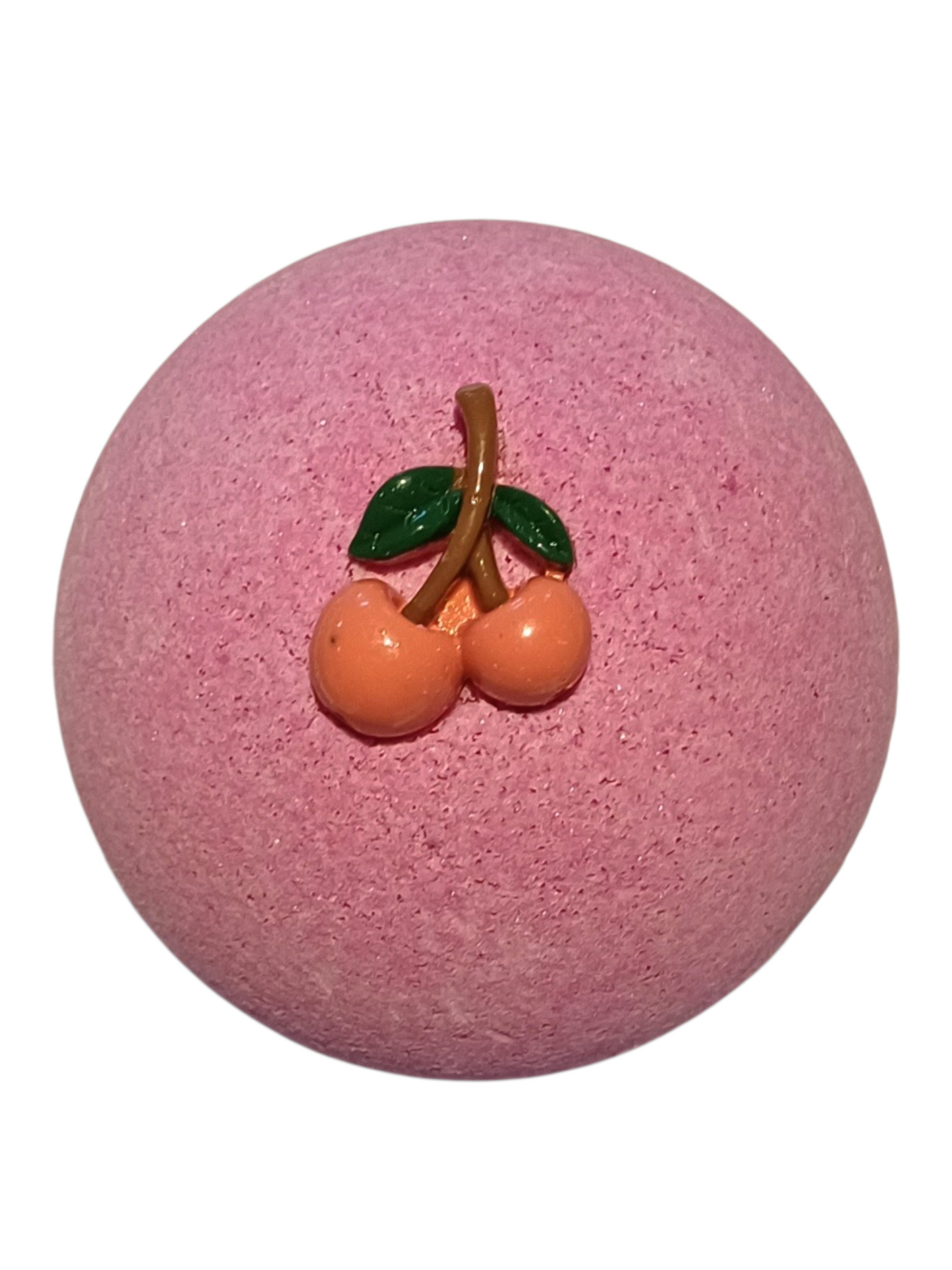 Purple bath bomb with red cherries and green leaves on top