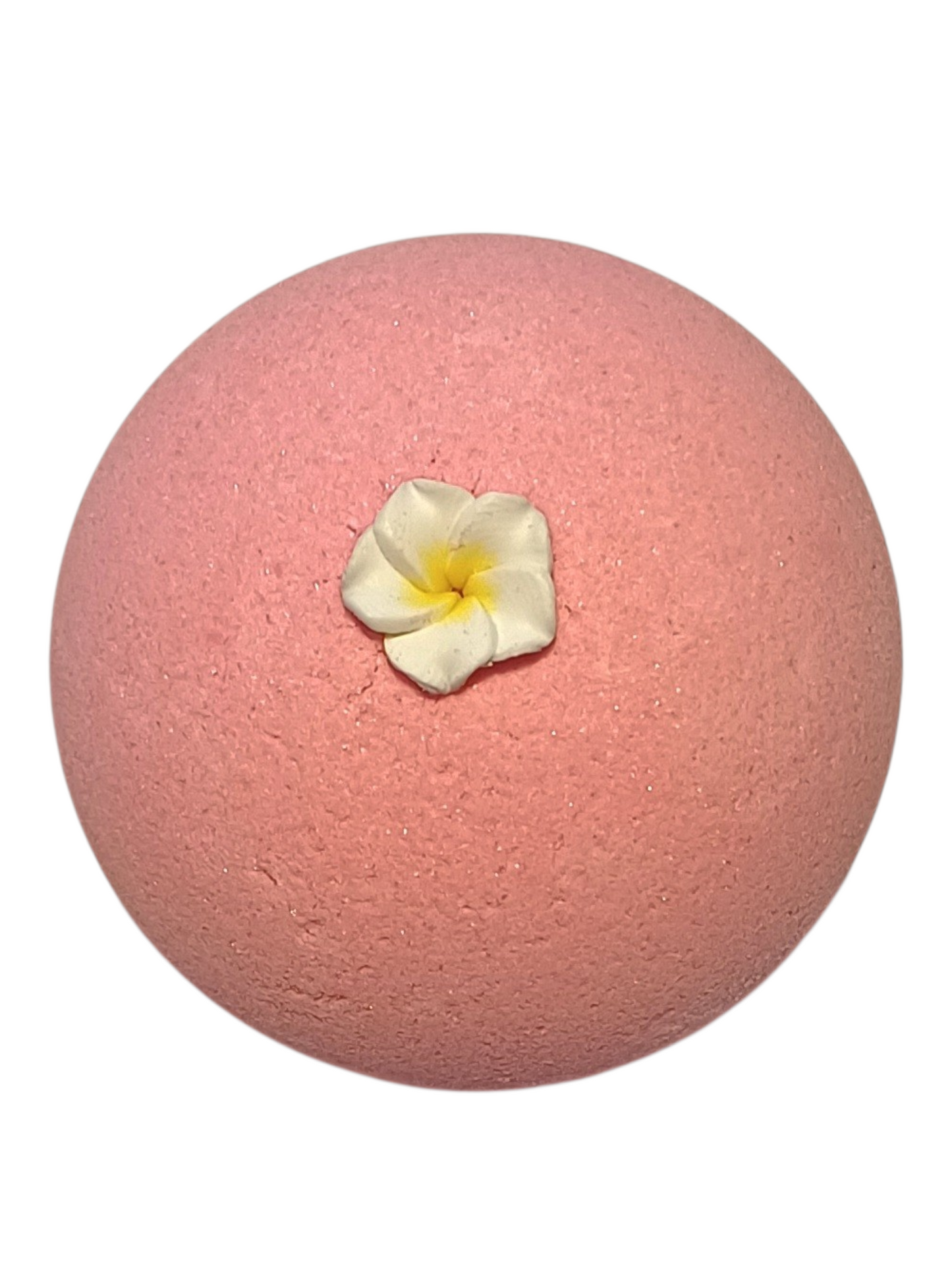 Pink bath bomb with a white flower on top.