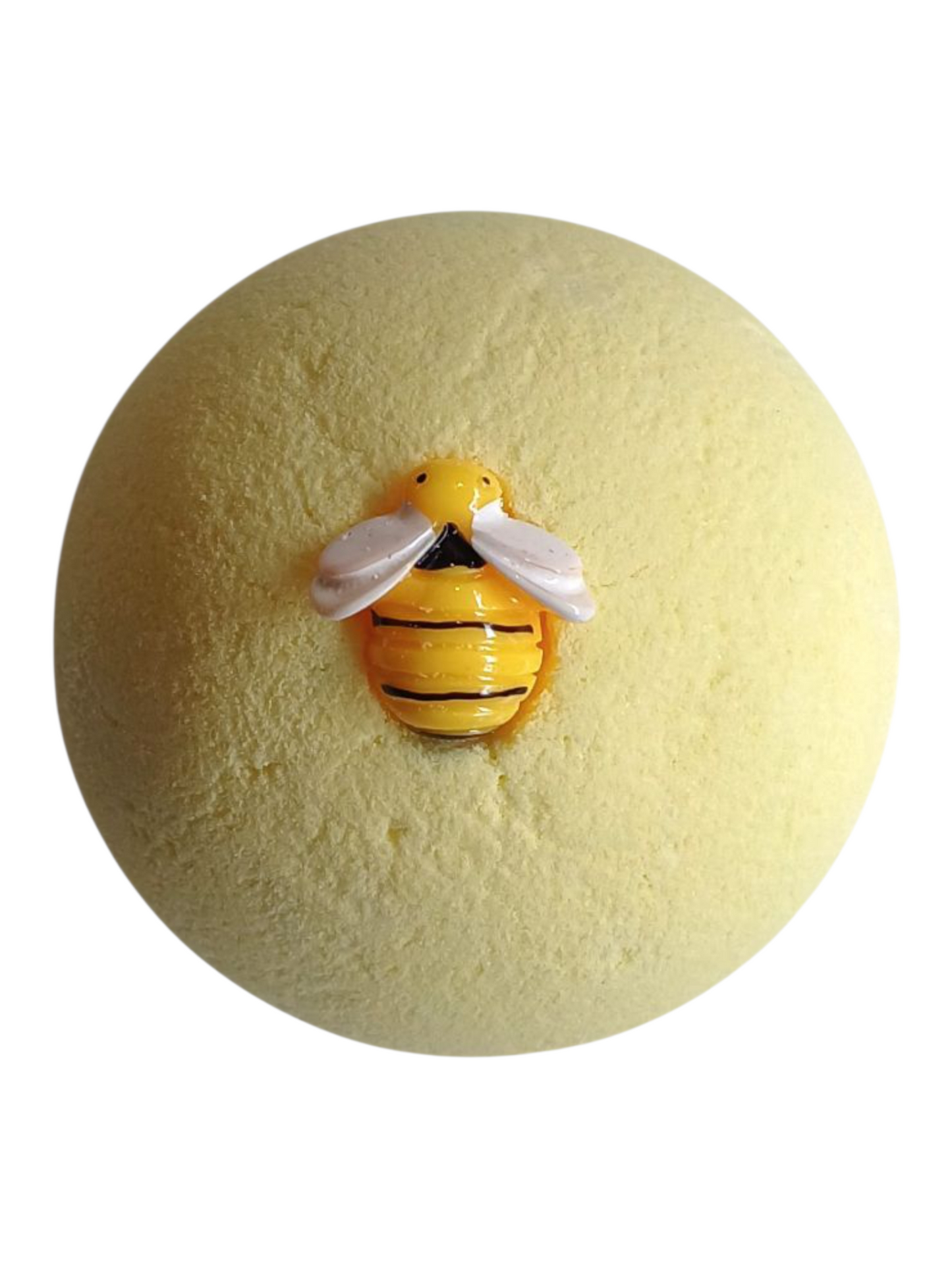 Yellow bath bomb with a bee-shaped figure on a white background