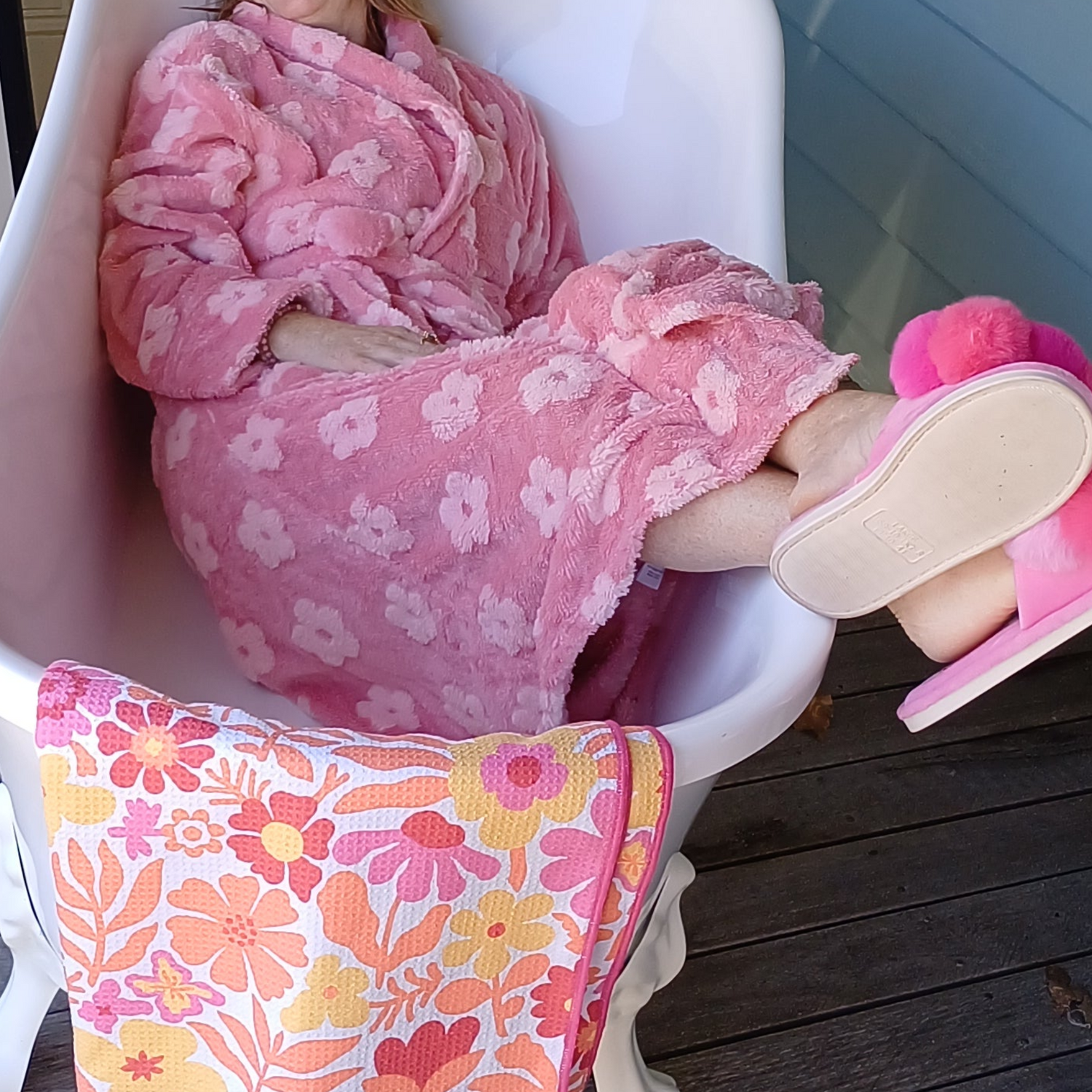 Lady wearing a pink robe and slippers in the bath