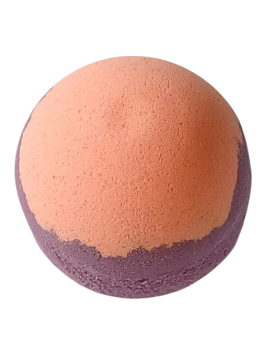 A round bath bomb with a layer design, featuring a textured peach-orange top half and a dark purple bottom middle and peach-orange bottom