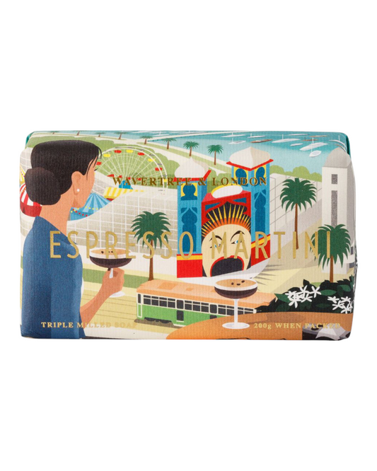 A soap bar with a colorful illustration featuring a person holding a glass of espresso martini, with architectural elements and palm trees in the background.