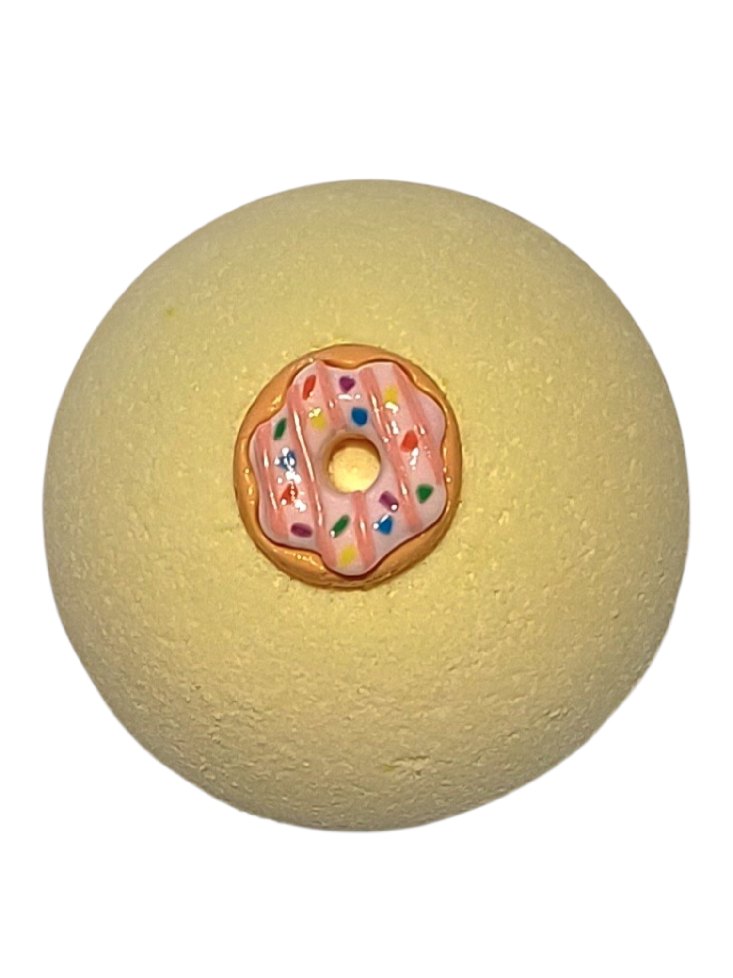 Yellow textured ball with a donut-shaped object on top